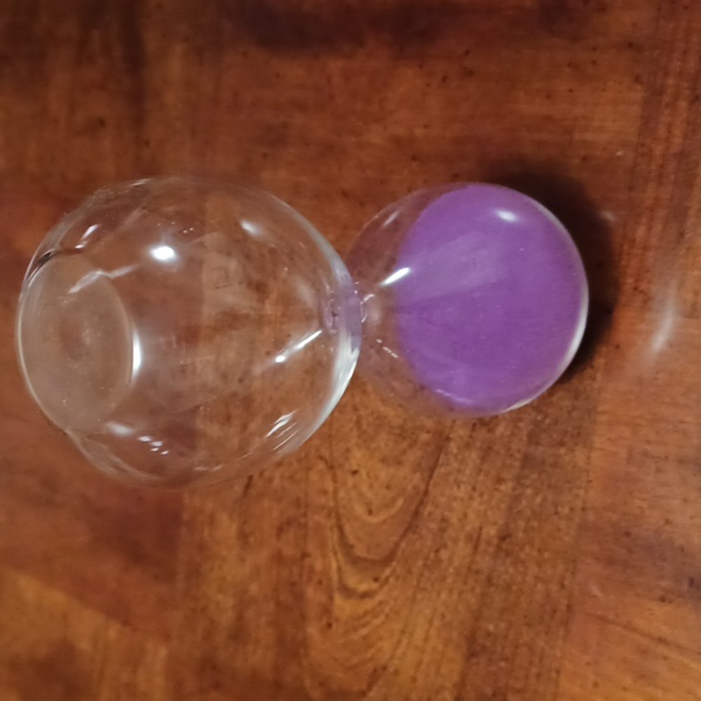 Hour glass with purple sand